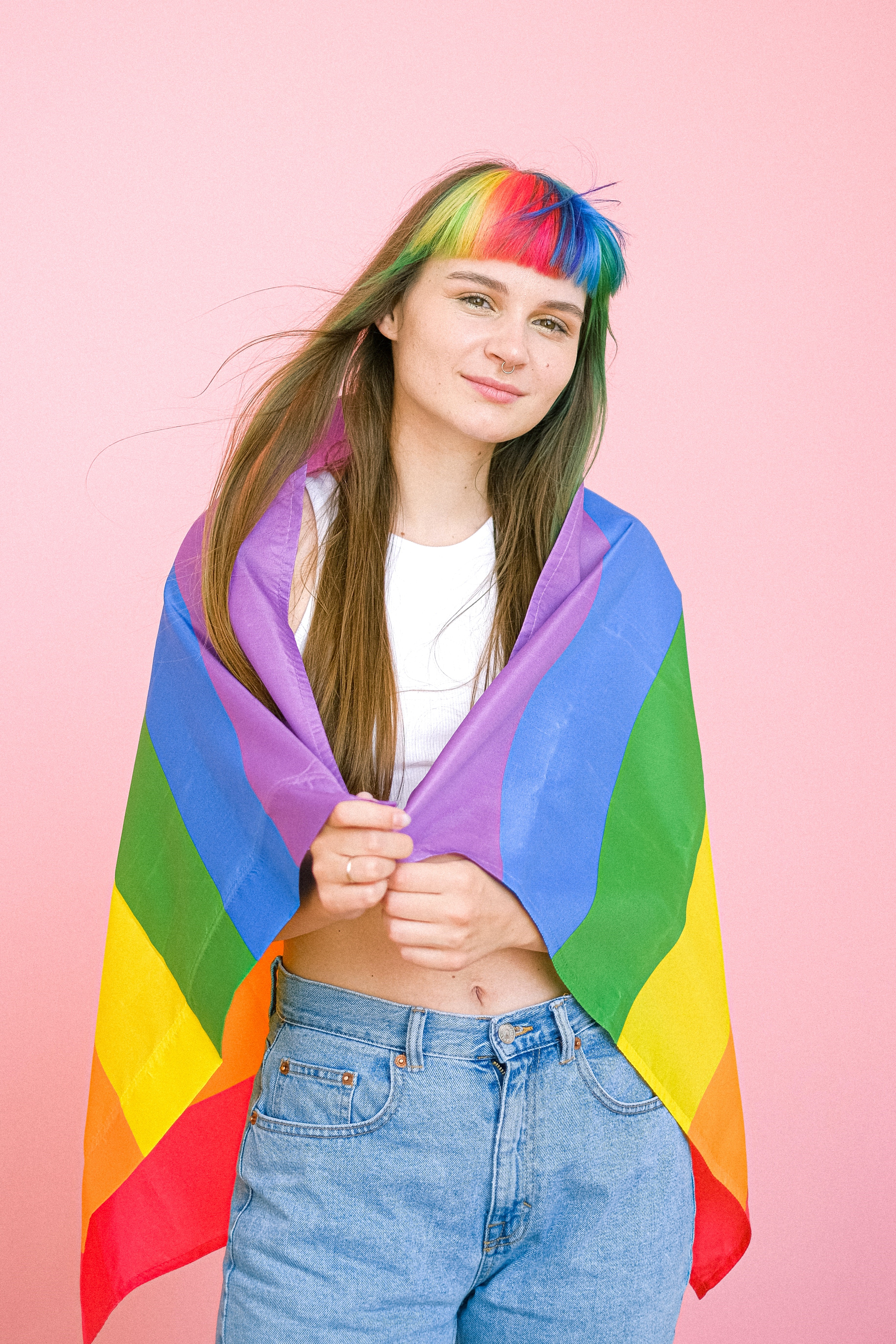 LGBTQ+ Person wearing rainbow flag